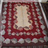 R38. Company C rug with a design of acorns and oak leaves. 